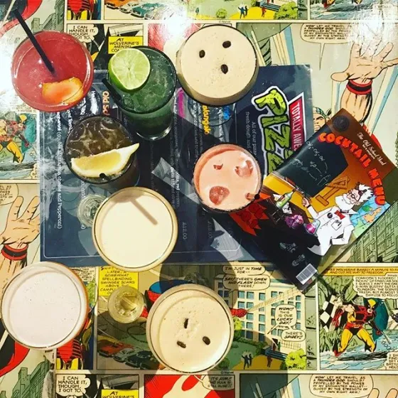 A round of cocktails on the comic-print table